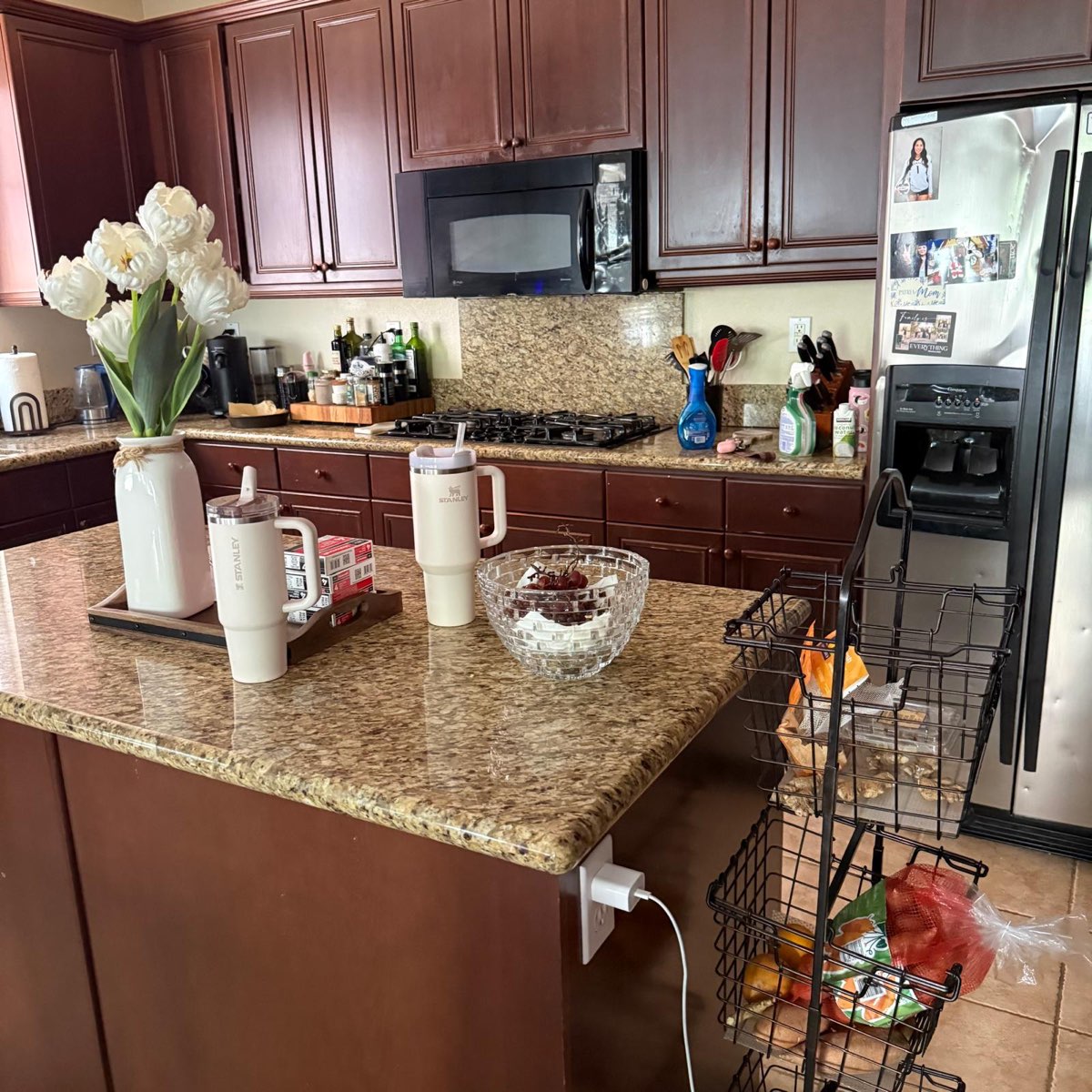 Kitchen before cleaning — counters cluttered and floor in use