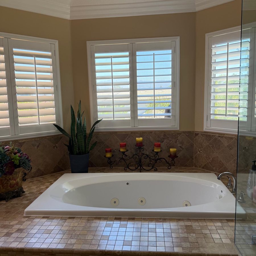 Spa bathroom with jetted tub and plantation shutters